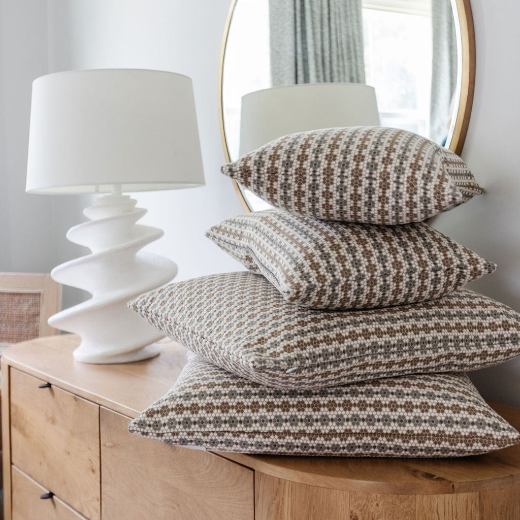 Nectar pillow in walnut — stacked pillows on a wooden dresser