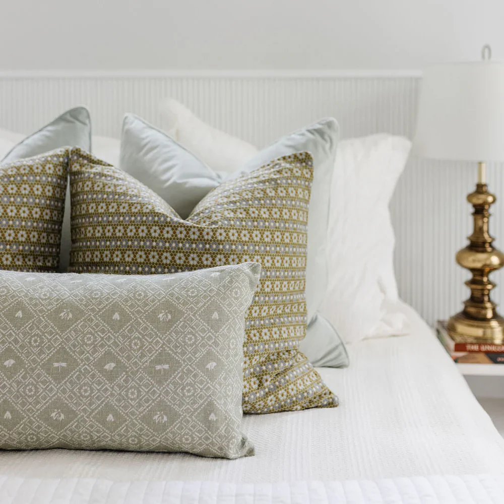 Nectar in Savannah styled on a bed with layered pillows