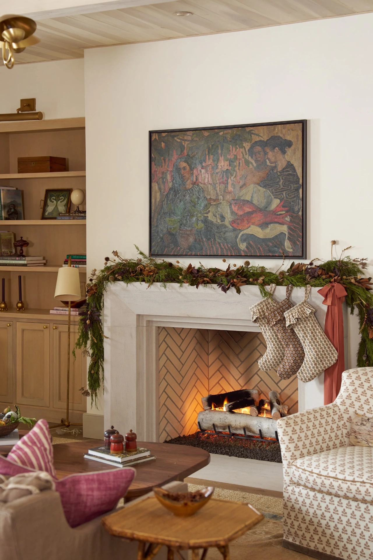 Fireplace mantel with garland, stockings, and Emily Daws Nectar fabric pillows