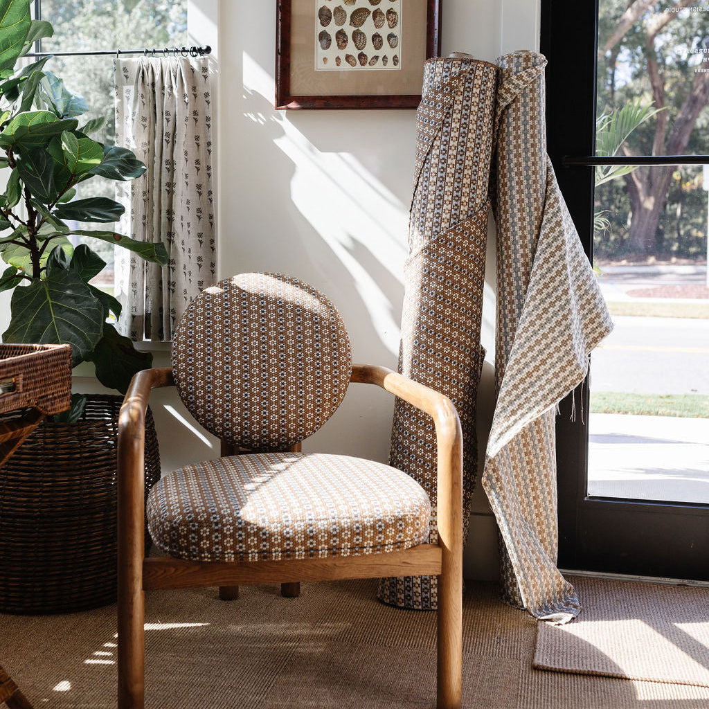 Speckled Check upholstered chair with fabric bolts in Emily Daws Charleston studio